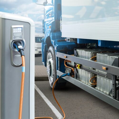 Hybrid electric truck being charging at charging station