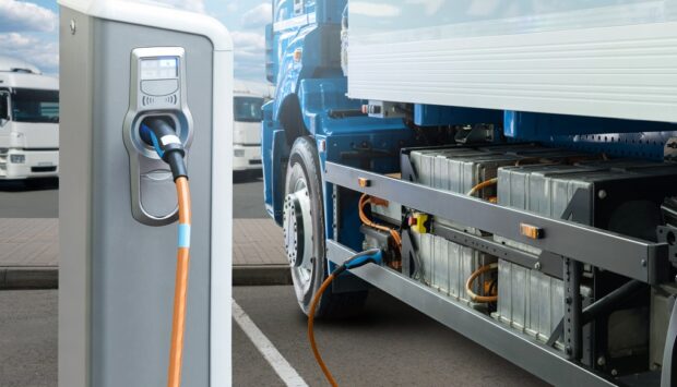 Hybrid electric truck being charging at charging station